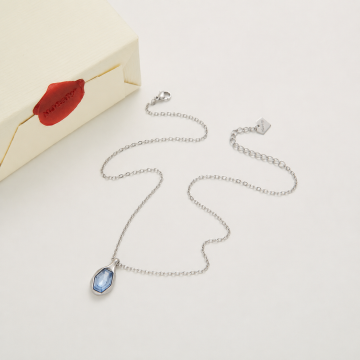 Silver necklace with Nucery wax seal packaging