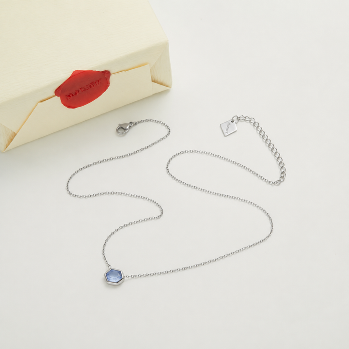 Silver necklace with Nucery wax seal packaging
