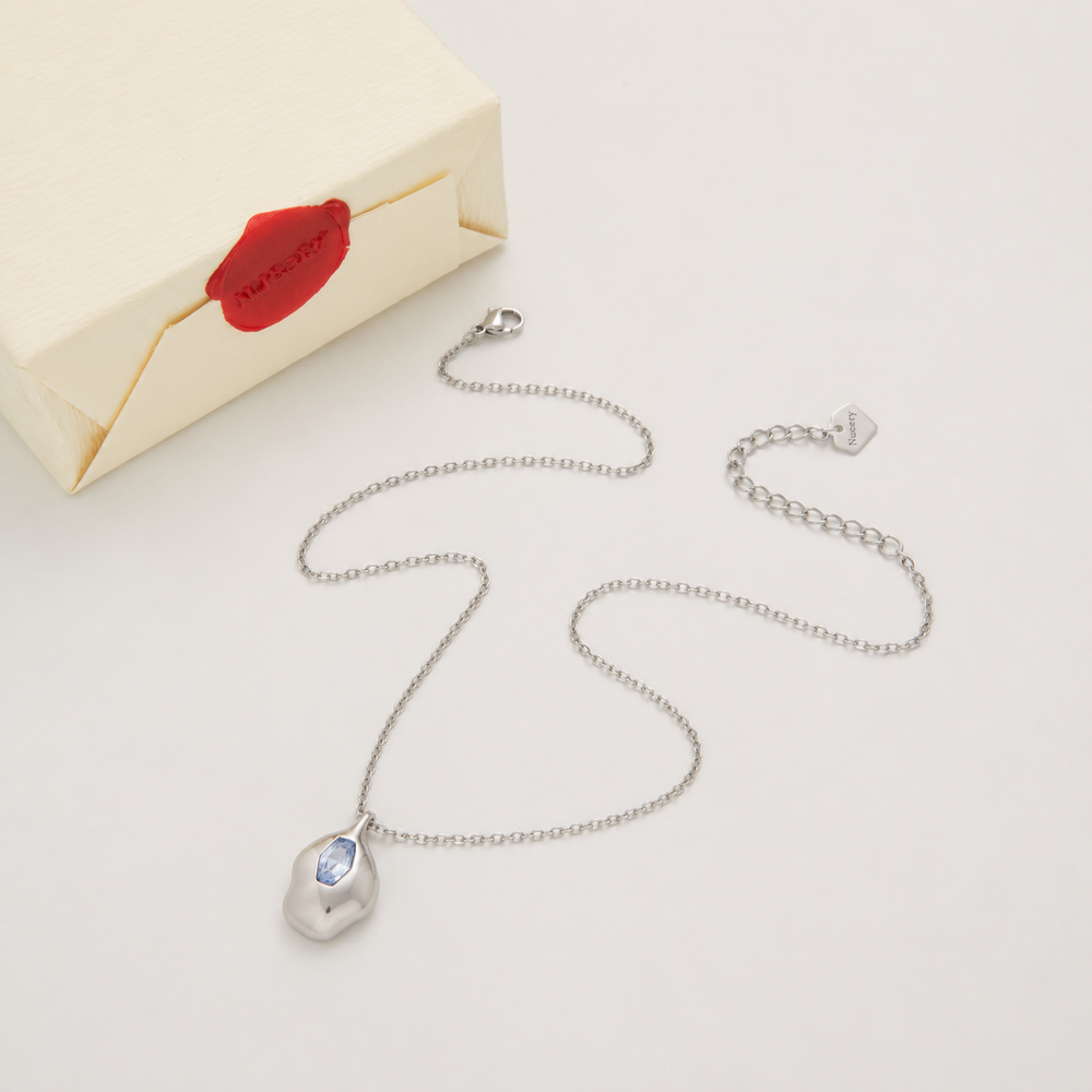 Silver necklace with Nucery wax seal packaging