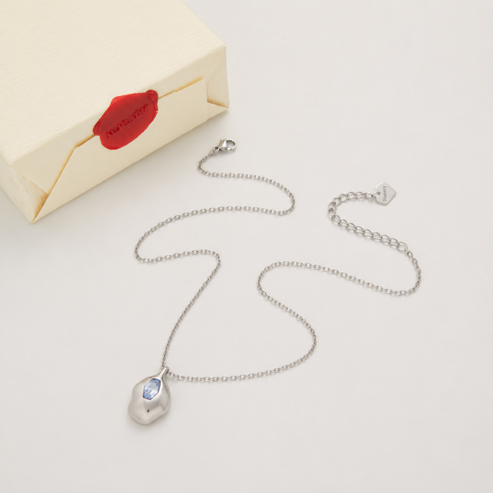 Silver necklace with Nucery wax seal packaging