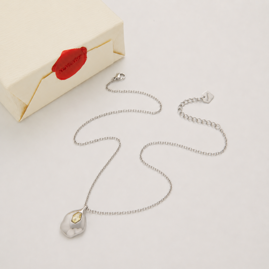 Silver necklace with Nucery wax seal packaging
