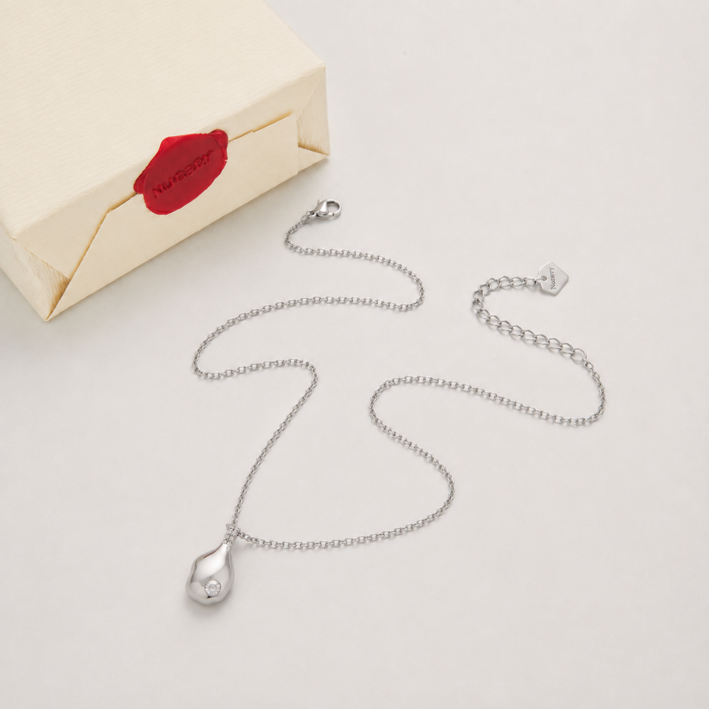 Silver necklace with Nucery wax seal packaging