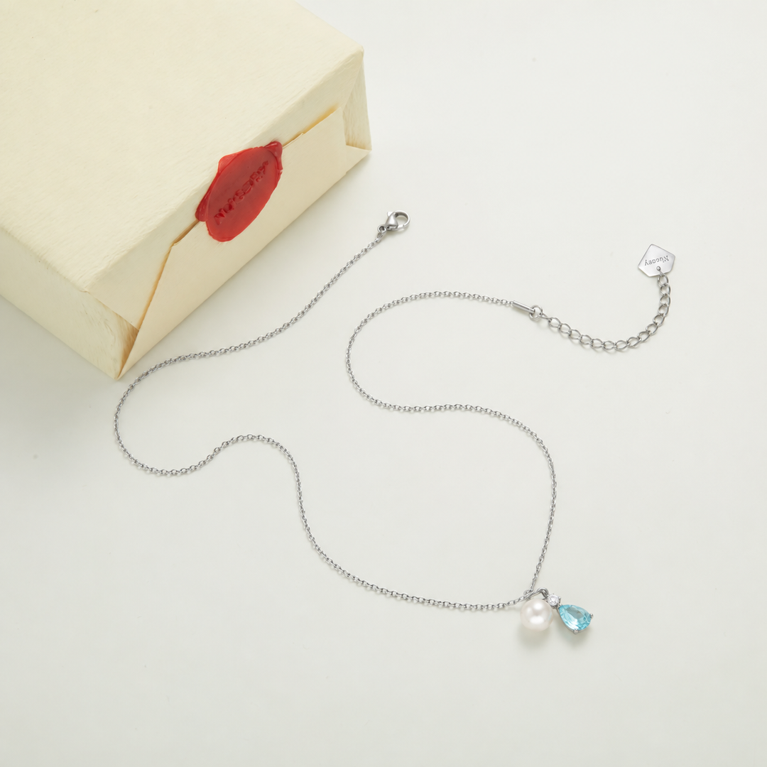 Silver necklace with Nucery wax seal packaging