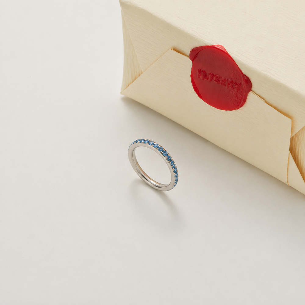 Silver ring with blue stones and Nucery wax seal packaging