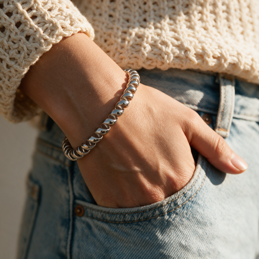 Silver bracelet worn on wrist, golden hour denim