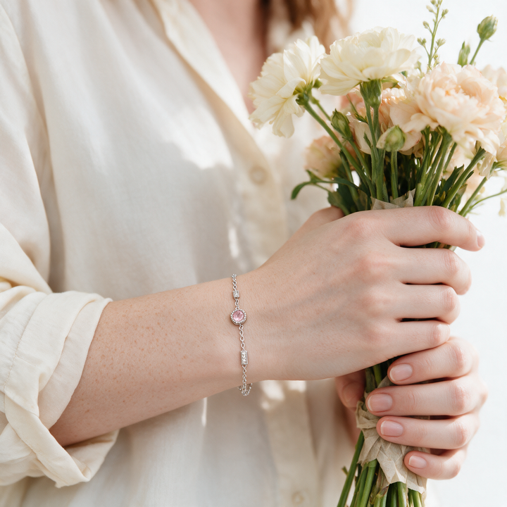 Silver bracelet on hand holding bouquet stems