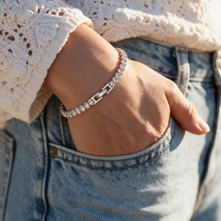 Silver bracelet worn on wrist, golden hour denim