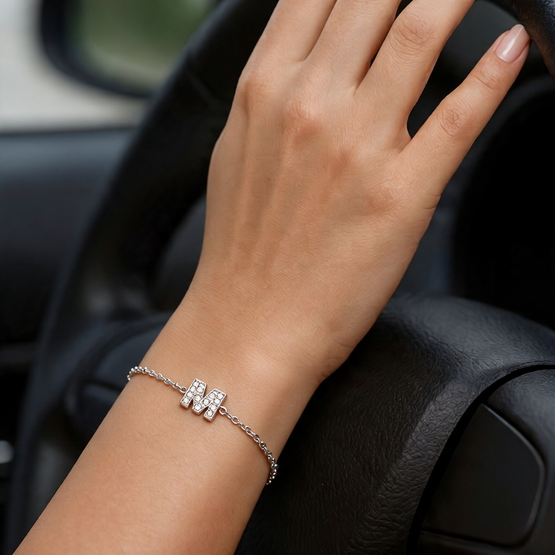 Silver bracelet worn on wrist, car interior