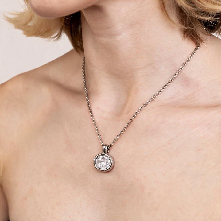 Silver necklace worn on neck