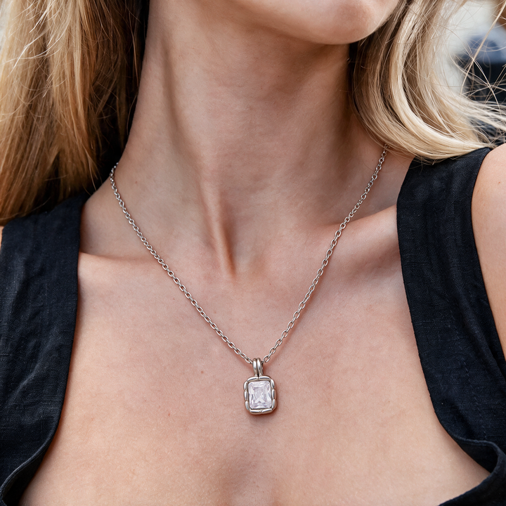 Silver necklace worn on neck