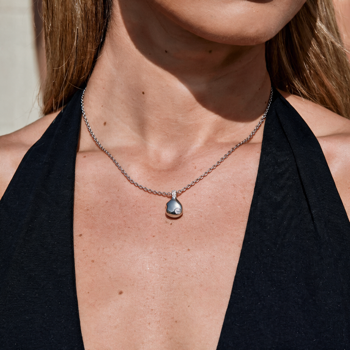 Silver necklace worn on neck
