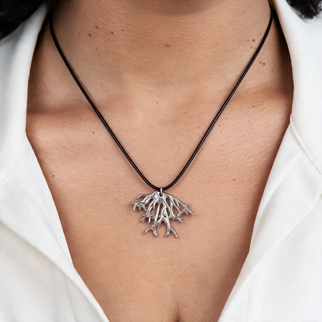 Silver necklace worn on neck