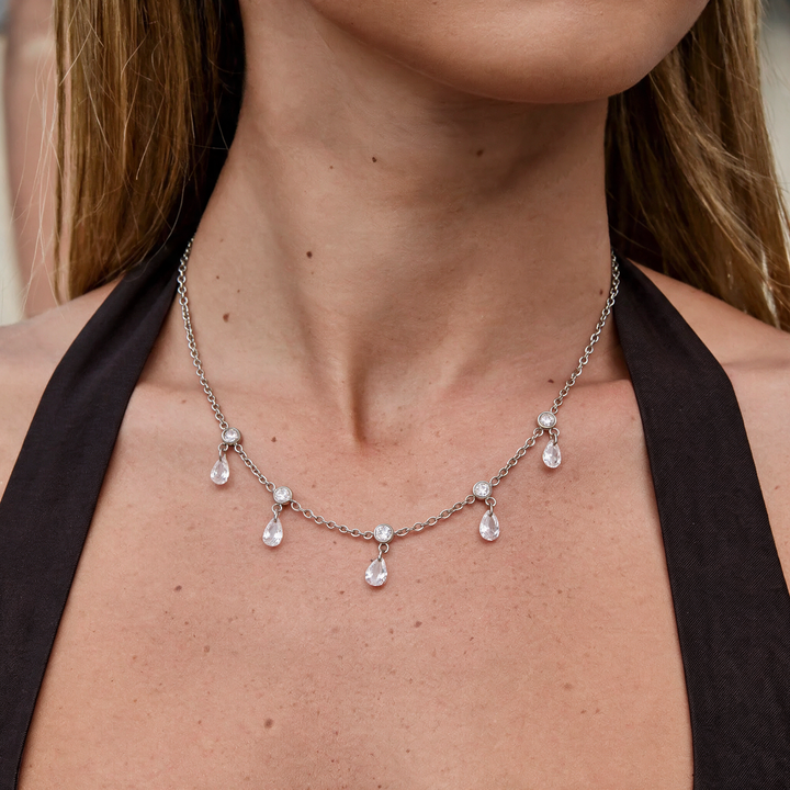 Silver necklace worn on neck