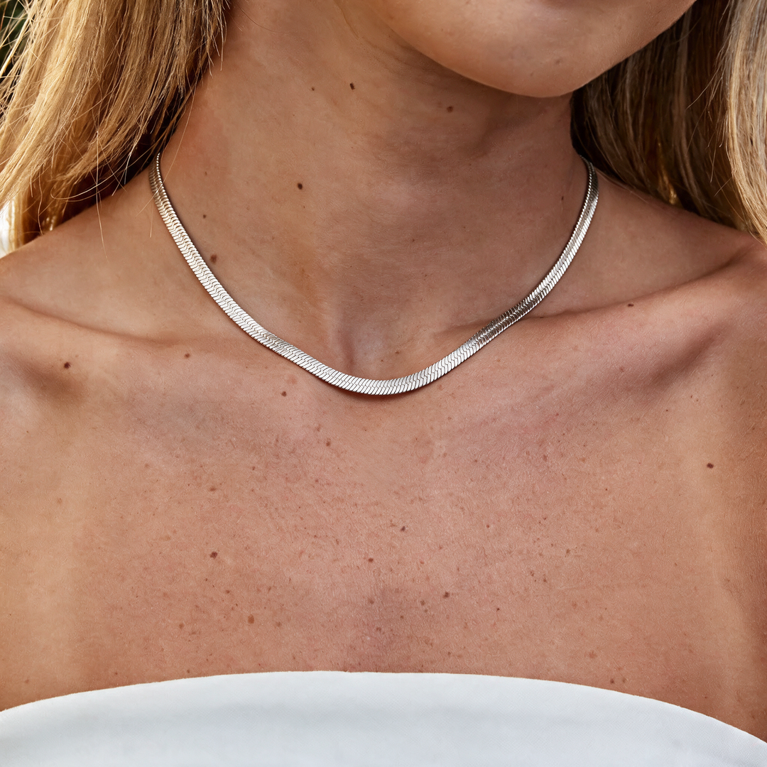 Silver necklace worn on neck