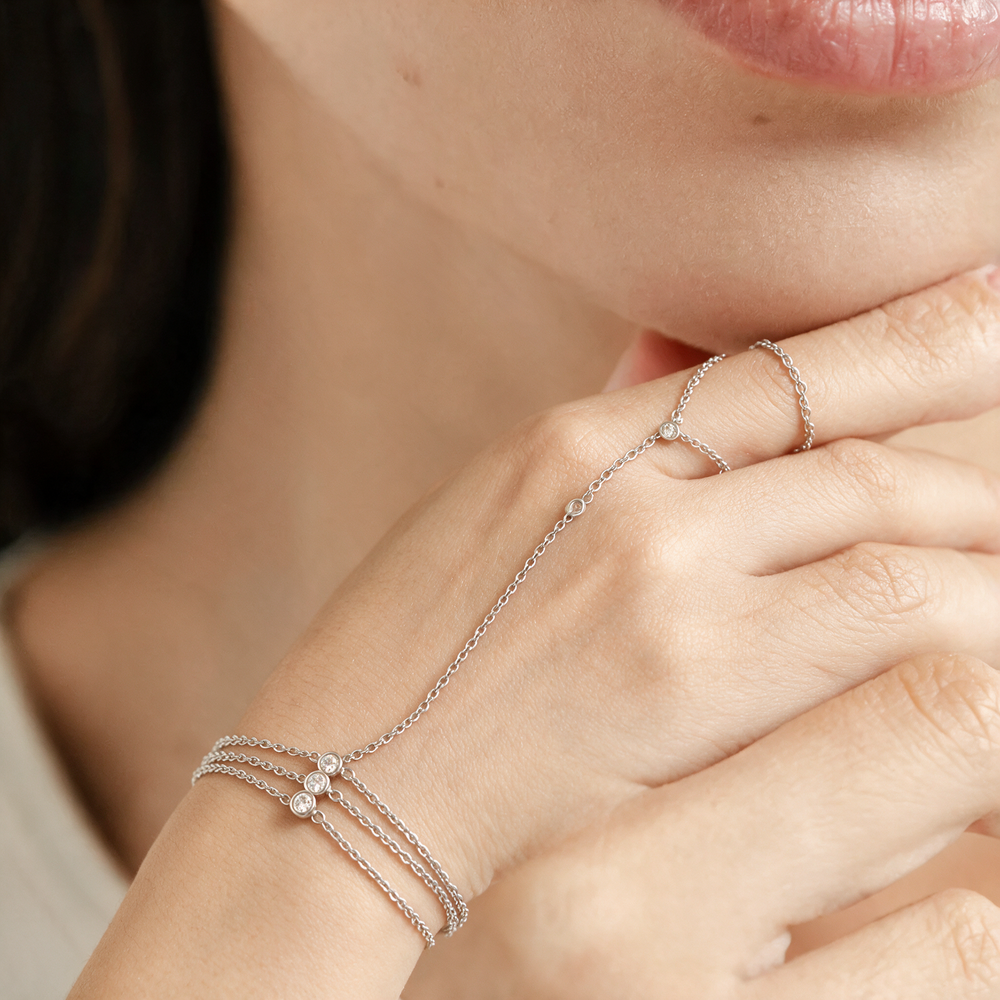 Silver hand chain worn on hand
