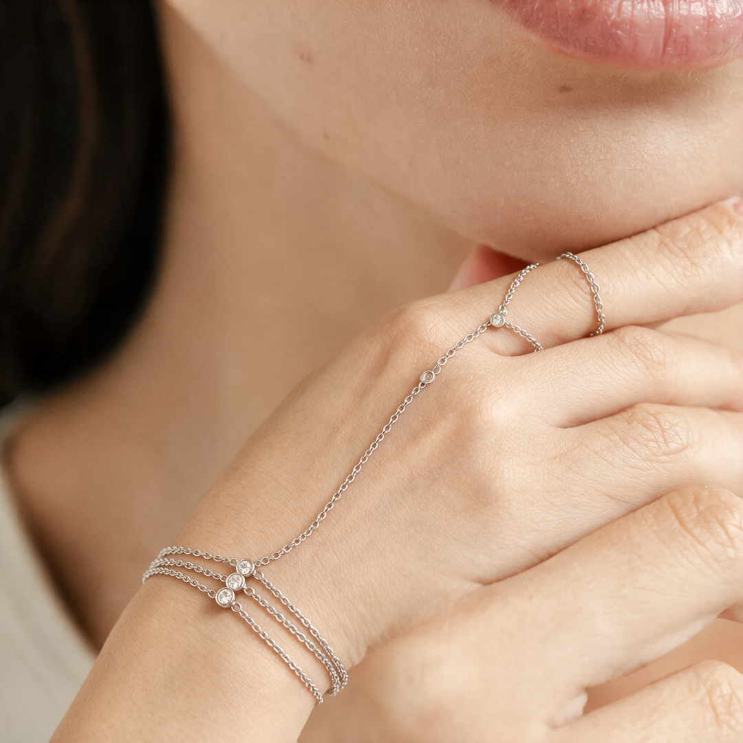 Silver hand chain worn on hand