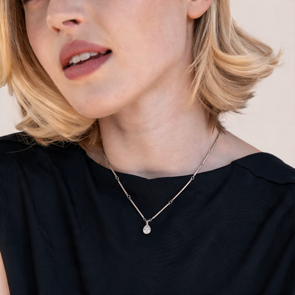 Silver necklace worn on neck
