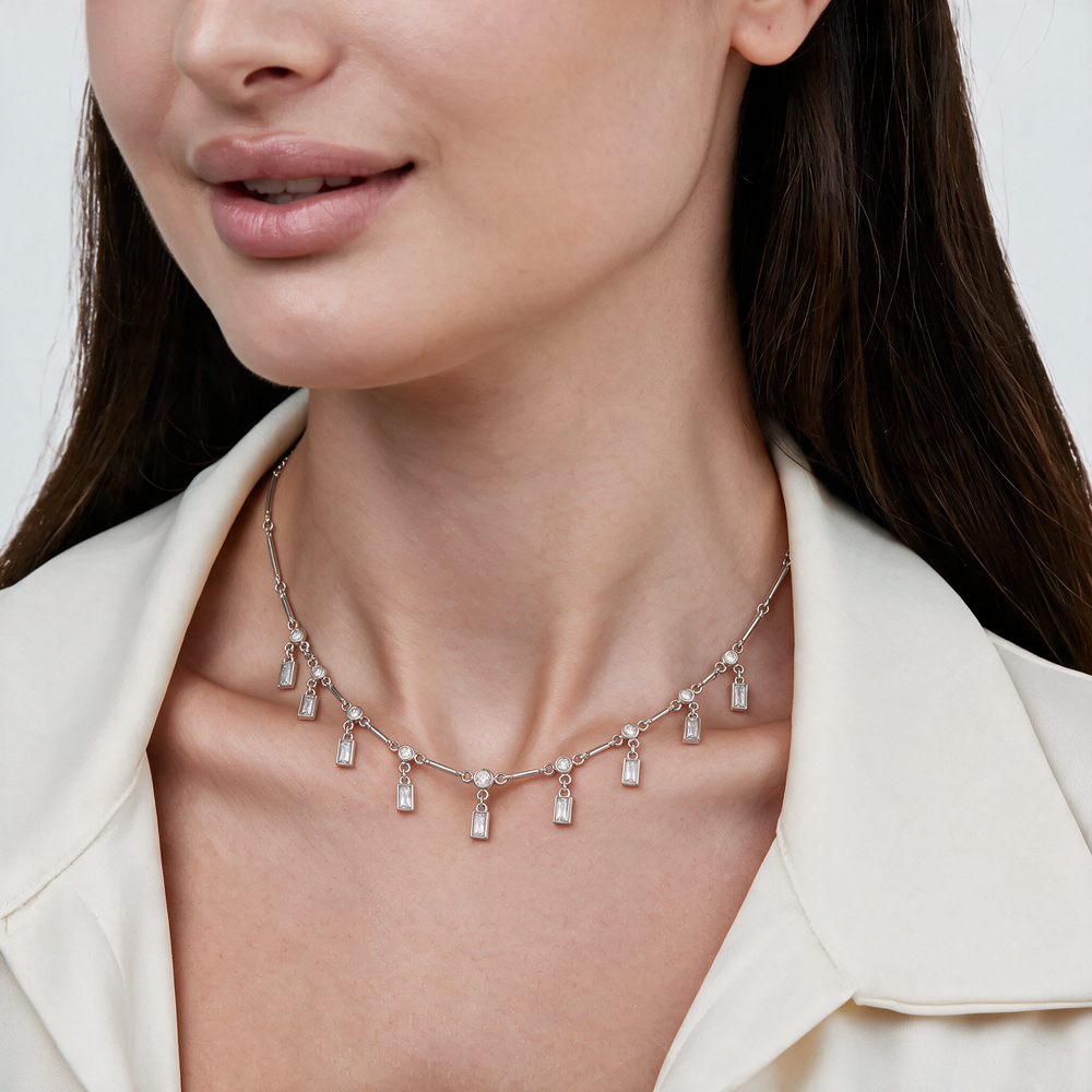 Silver station drop necklace worn on neck